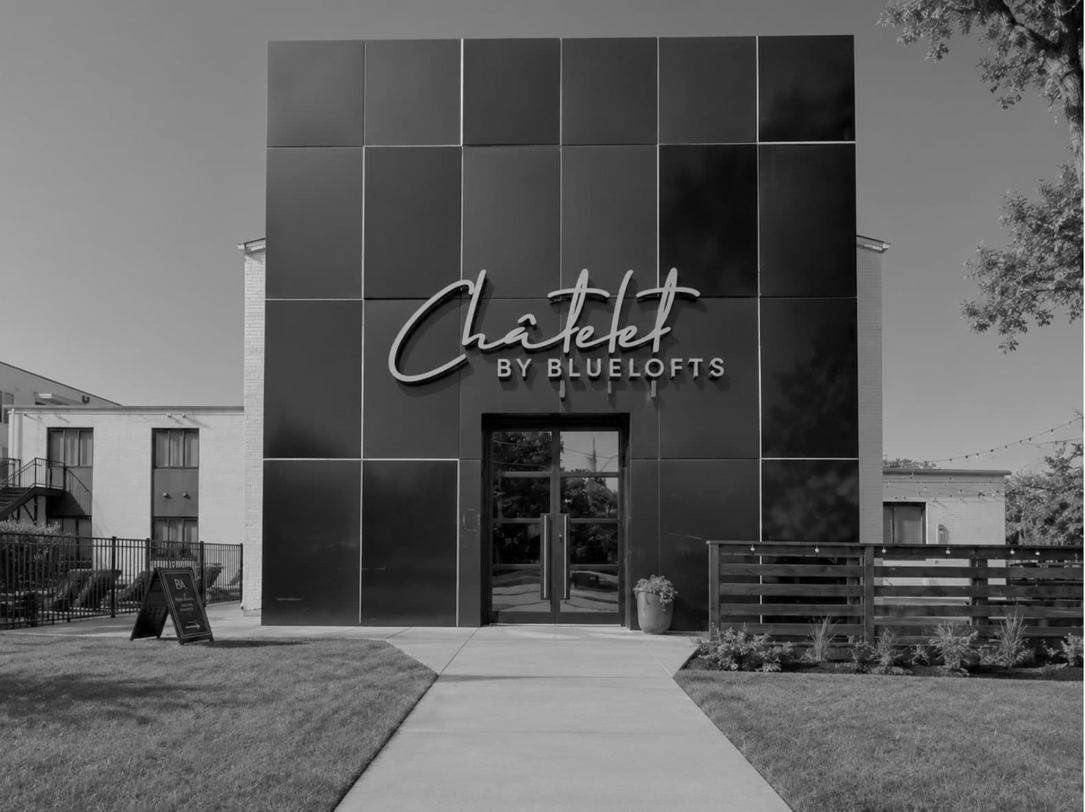 The Châtelet by BlueLofts entrance with its illuminated copper wordmark