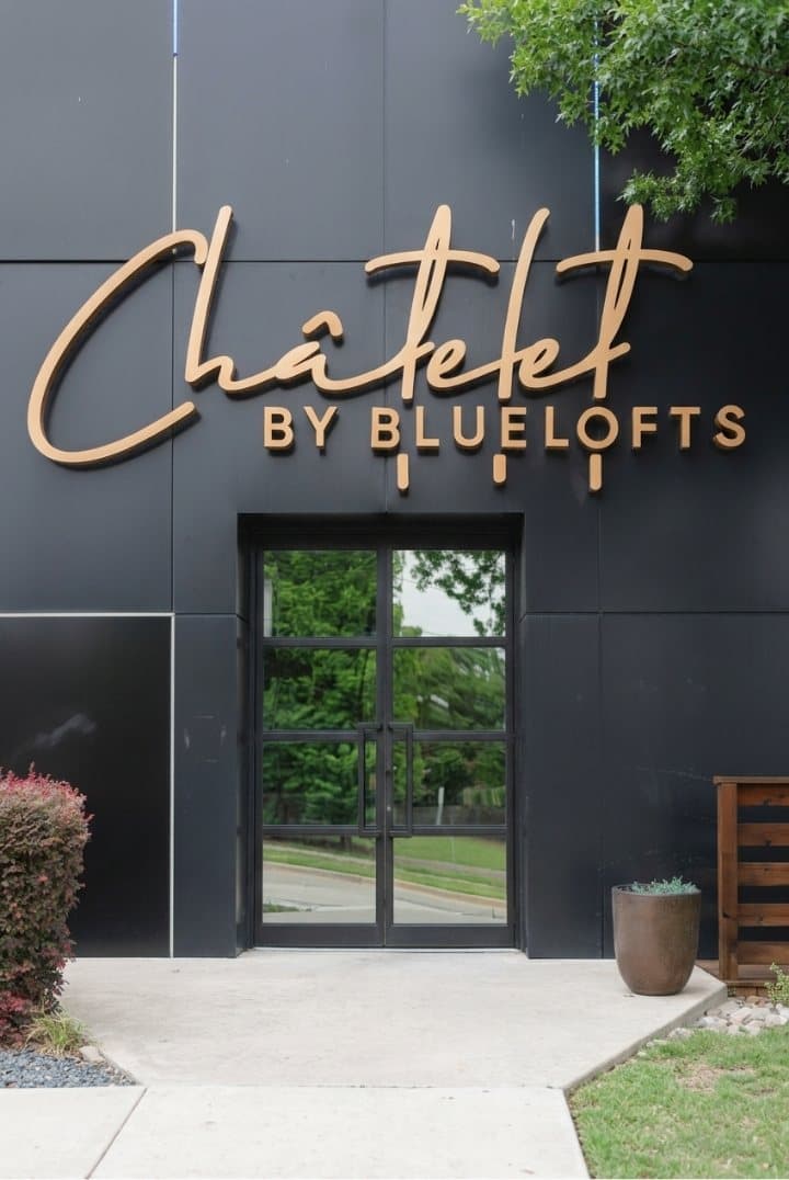 The Châtelet by BlueLofts entrance and its illuminated copper wordmark