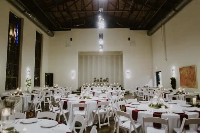 Reception hall set with white linens for a wedding