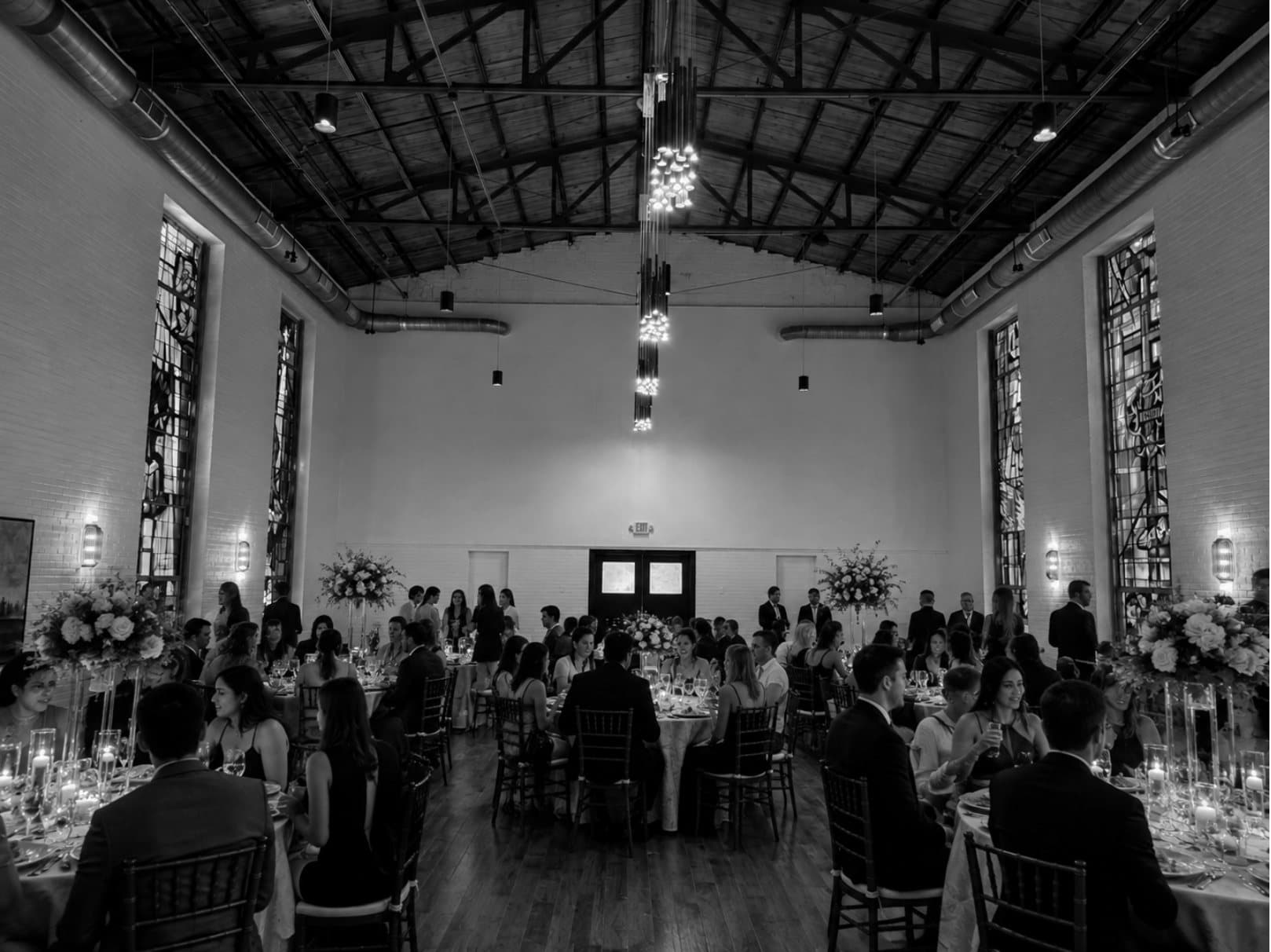 A full reception in progress beneath the venue's exposed ceiling