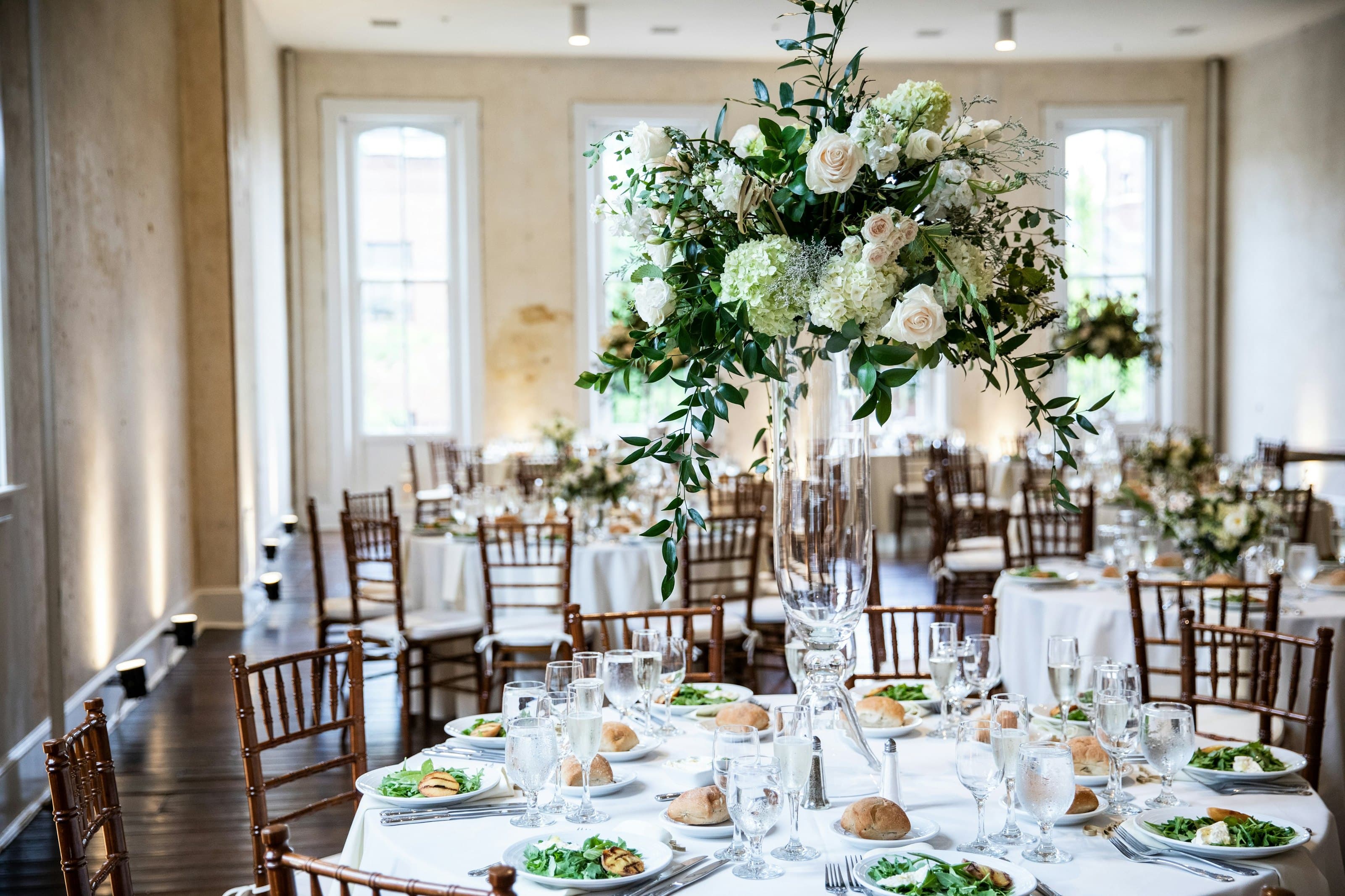 A long table dressed with silver candelabra and place settings