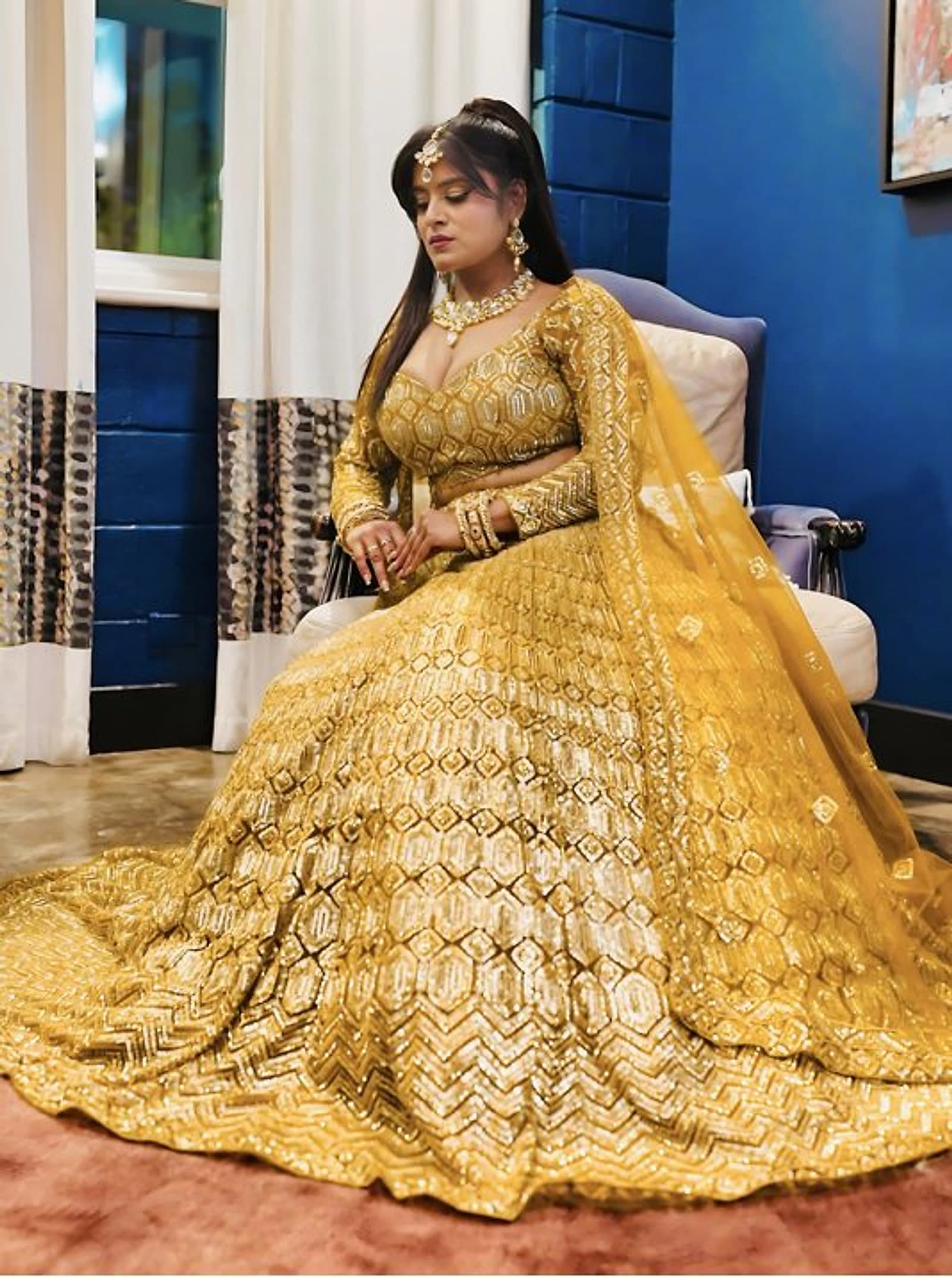 A guest in a gold gown seated for a celebration at Châtelet