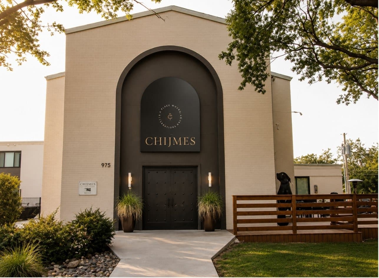 The arched facade and reclaimed-wood fence at the front of the venue
